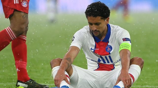 Paris Saint-Germain's Brazilian defender Marquinhos sits injured just after scoring the 0-2 goal and has to go off during the UEFA Champions League quarter-final first leg football match between FC Bayern Munich and Paris Saint-Germain (PSG) in Munich, southern Germany, on April 7, 2021.
