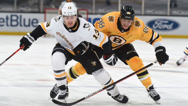 BOSTON, MA - APRIL 3: Brandon Tanev #13 of the Pittsburgh Penguins skates against David Pastrnak #88 of the Boston Bruins at the TD Garden on April 3, 2021 in Boston, Massachusetts.