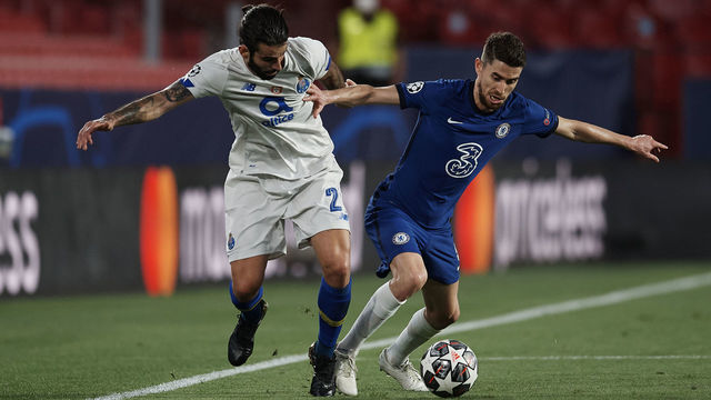 Sergio Oliveira of Porto and Jorginho of Chelsea compete for the ball during the UEFA Champions League Quarter Final Second Leg match between Chelsea FC and FC Porto at Estadio Ramon Sanchez Pizjuan on April 13, 2021 in Seville, Spain. Sporting stadiums around Spain remain under strict restrictions due to the Coronavirus Pandemic as Government social distancing laws prohibit fans inside venues resulting in games being played behind closed doors.