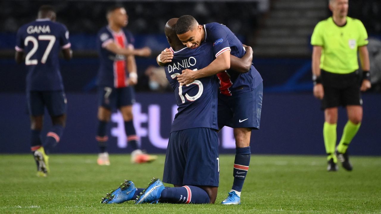 Paris Saint-Germain's Portuguese midfielder Danilo Pereira (L) and Paris Saint-Germain's French defender Colin Dagba celebrate after winning the UEFA Champions League quarter-final second leg football match between Paris Saint-Germain (PSG) and FC Bayern Munich at the Parc des Princes stadium in Paris, on April 13, 2021.