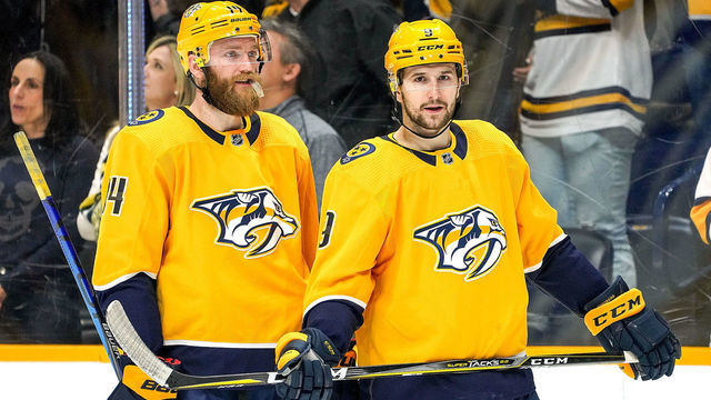 NASHVILLE, TN - FEBRUARY 22: Filip Forsberg #9 and Mattias Ekholm #14 of the Nashville Predators prepare for a face-off against the Columbus Blue Jackets at Bridgestone Arena on February 22, 2020 in Nashville, Tennessee.