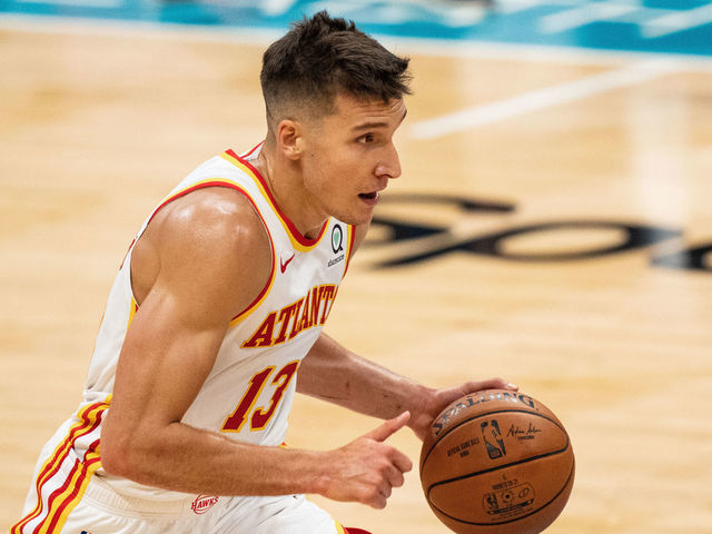 CHARLOTTE, NORTH CAROLINA - APRIL 11: Bogdan Bogdanovic #13 of the Atlanta Hawks brings the ball up court against the Charlotte Hornets in the first half during their game at Spectrum Center on April 11, 2021 in Charlotte, North Carolina.