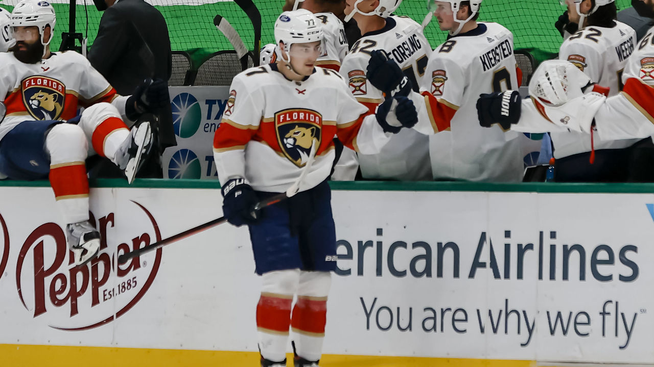DALLAS, TX - APRIL 10: Florida Panthers center Frank Vatrano (77) gets fist bumps from his teammates after scoring a goal during the game between the Dallas Stars and the Florida Panthers on April 10, 2021 at American Airlines Center in Dallas, Texas.
