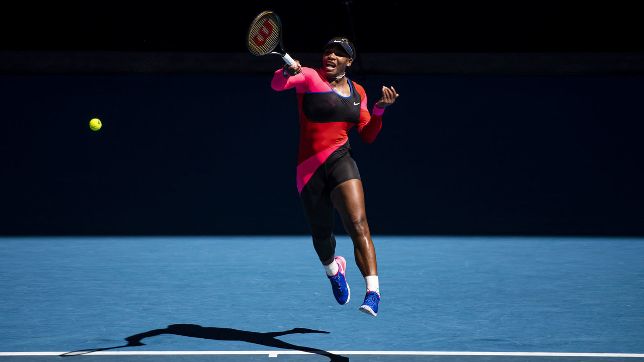 MELBOURNE, AUSTRALIA - FEBRUARY 18: Serena Williams of the United States hits a backhand against Naomi Osaka of Japan in the women's singles semi-finals during day 11 of the 2021 Australian Open at Melbourne Park on February 18, 2021 in Melbourne, Australia.