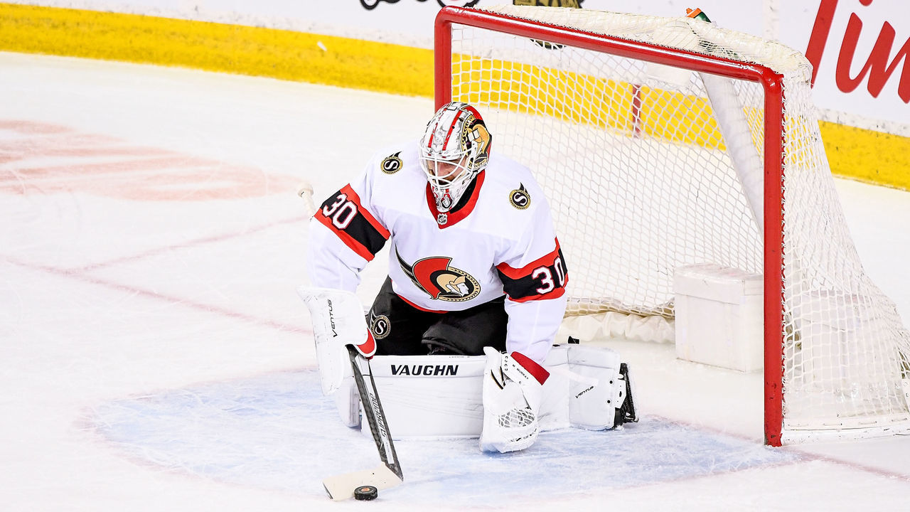 CALGARY, AB - MARCH 07: Ottawa Senators Goalie Matt Murray (30) plays the puck during the first period of an NHL game where the Calgary Flames hosted the Ottawa Senators on March 7, 2021, at the Scotiabank Saddledome in Calgary, AB.