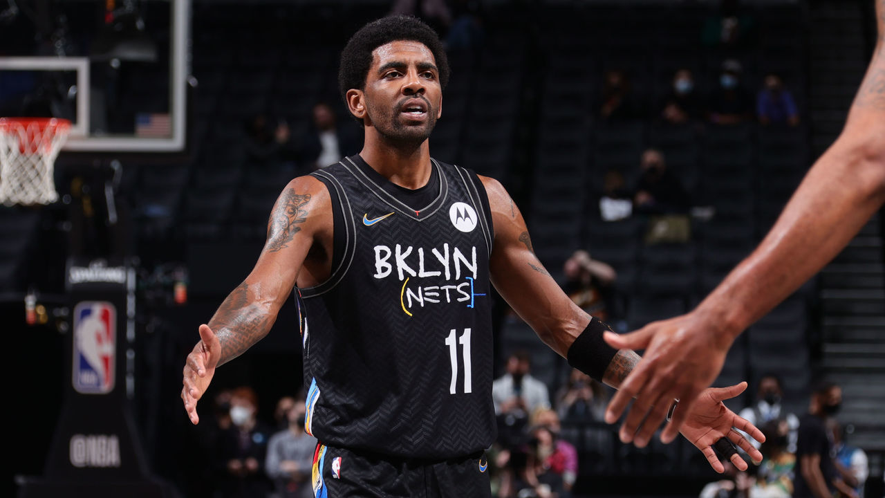BROOKLYN, NY - APRIL 10: Kyrie Irving #11 of the Brooklyn Nets hi-fives his teammates during the game against the Los Angeles Lakers on April 10, 2021 at Barclays Center in Brooklyn, New York. Mandatory Copyright Notice: Copyright 2021 NBAE