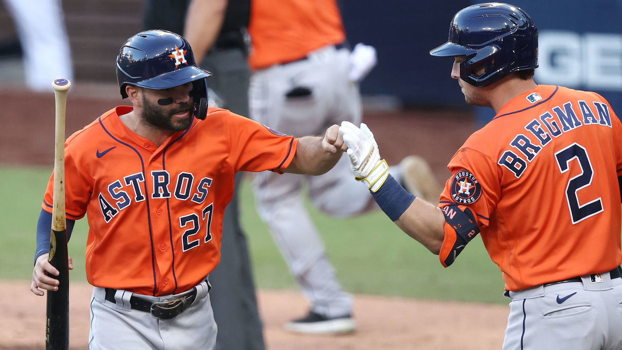 SAN DIEGO, CALIFORNIA - OCTOBER 16: Jose Altuve #27 of the Houston Astros celebrates with Alex Bregman #2 after scoring on a Willy Adames #1 RBI single against the Tampa Bay Rays during the fifth inning in Game Six of the American League Championship Series at PETCO Park on October 16, 2020 in San Diego, California.