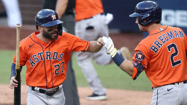 SAN DIEGO, CALIFORNIA - OCTOBER 16: Jose Altuve #27 of the Houston Astros celebrates with Alex Bregman #2 after scoring on a Willy Adames #1 RBI single against the Tampa Bay Rays during the fifth inning in Game Six of the American League Championship Series at PETCO Park on October 16, 2020 in San Diego, California.