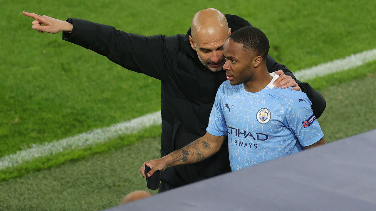 DORTMUND, GERMANY - APRIL 14: Pep Guardiola, Manager of Manchester City speaks with Substitute, Raheem Sterling of Manchester City during the UEFA Champions League Quarter Final Second Leg match between Borussia Dortmund and Manchester City at Signal Iduna Park on April 14, 2021 in Dortmund, Germany. Sporting stadiums around Germany remain under strict restrictions due to the Coronavirus Pandemic as Government social distancing laws prohibit fans inside venues resulting in games being played behind closed doors.