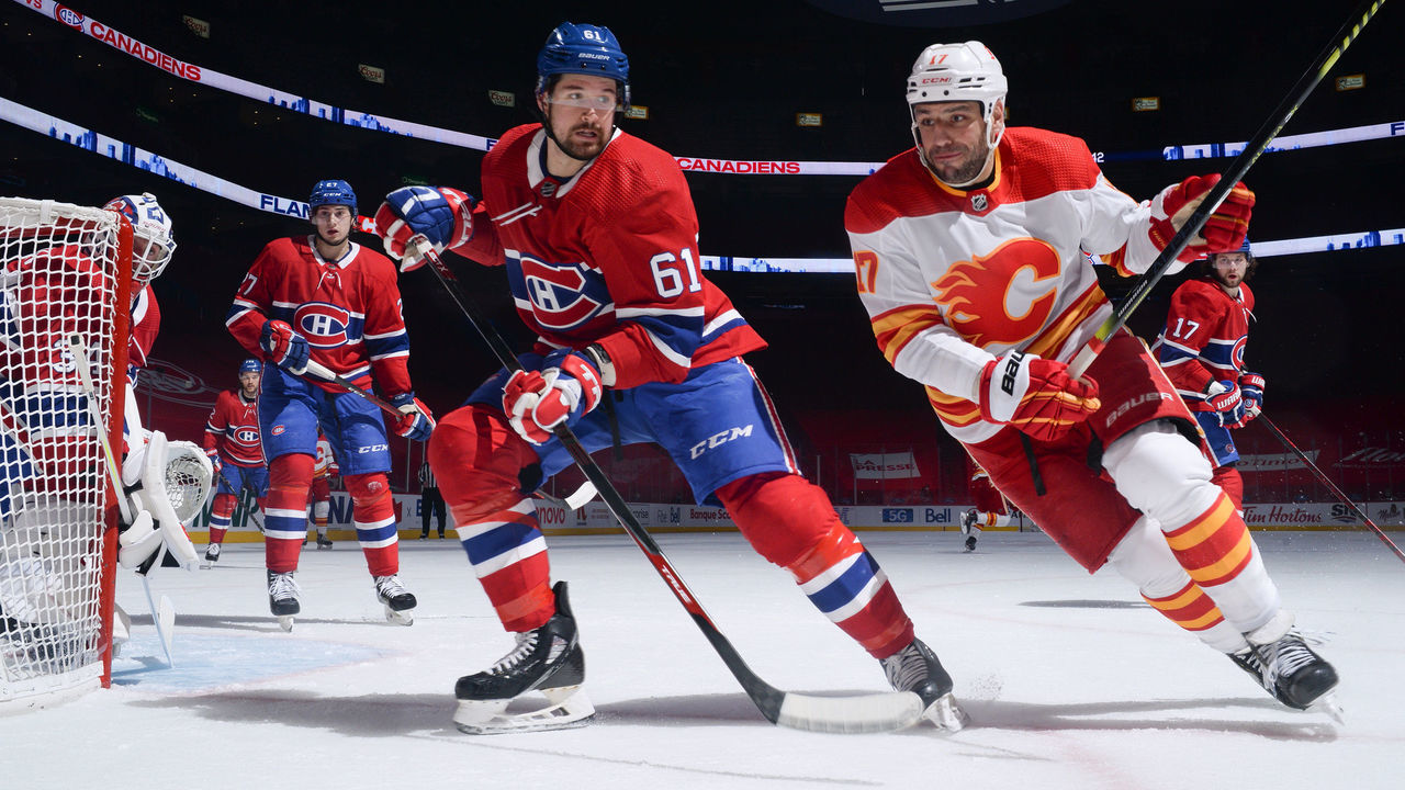 MONTREAL, QC - APRIL 14: Xavier Ouellet #61 of the Montreal Canadiens defends against Milan Lucic #17 of the Calgary Flames in the NHL game at the Bell Centre on April 14, 2021 in Montreal, Quebec, Canada.