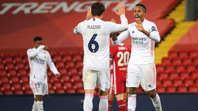 LIVERPOOL, ENGLAND - APRIL 14: Eder Militao of Real Madrid celebrates victory with team mate Nacho following the UEFA Champions League Quarter Final Second Leg match between Liverpool FC and Real Madrid at Anfield on April 14, 2021 in Liverpool, England. Sporting stadiums around the UK remain under strict restrictions due to the Coronavirus Pandemic as Government social distancing laws prohibit fans inside venues resulting in games being played behind closed doors.