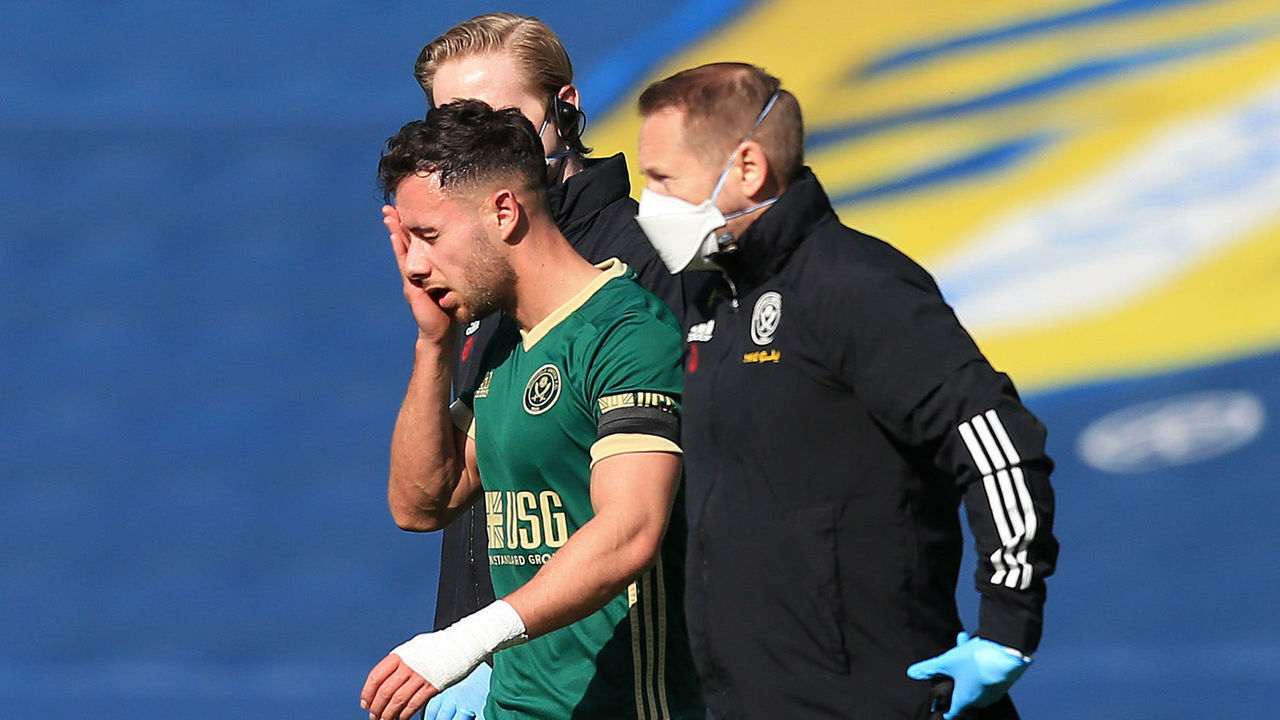 LEEDS, ENGLAND - APRIL 03: George Baldock of Sheffield United leaves the pitch with an injury during the Premier League match between Leeds United and Sheffield United at Elland Road on April 03, 2021 in Leeds, England. Sporting stadiums around the UK remain under strict restrictions due to the Coronavirus Pandemic as Government social distancing laws prohibit fans inside venues resulting in games being played behind closed doors.