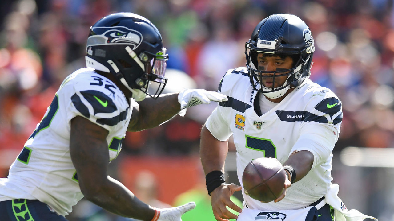 CLEVELAND, OH - OCTOBER 13, 2019: Quarterback Russell Wilson #3 of the Seattle Seahawks hands off the running back Chris Carson #32 of the Seattle Seahawks in the second quarter of a game against the Cleveland Browns on October 13, 2019 at FirstEnergy Stadium in Cleveland, Ohio. Seattle won 32-28. (Photo by: 2019 Nick Cammett/Diamond Images via Getty Images)