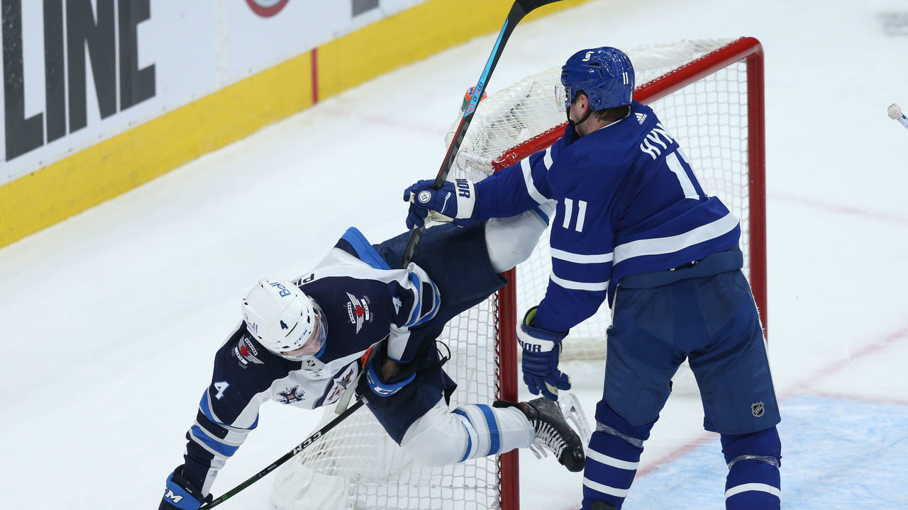 TORONTO ON- APRIL 15. Toronto Maple Leafs forward Zach Hyman (11) and Winnipeg Jets defenceman Neal Pionk (4) get engaged in some rough hockey in third period NHL action in Toronto on Thursday. (Rene Johnston/Toronto Star) (Rene Johnston/Toronto Star via Getty Images)