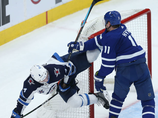 TORONTO ON- APRIL 15. Toronto Maple Leafs forward Zach Hyman (11) and Winnipeg Jets defenceman Neal Pionk (4) get engaged in some rough hockey in third period NHL action in Toronto on Thursday. (Rene Johnston/Toronto Star) (Rene Johnston/Toronto Star via Getty Images)