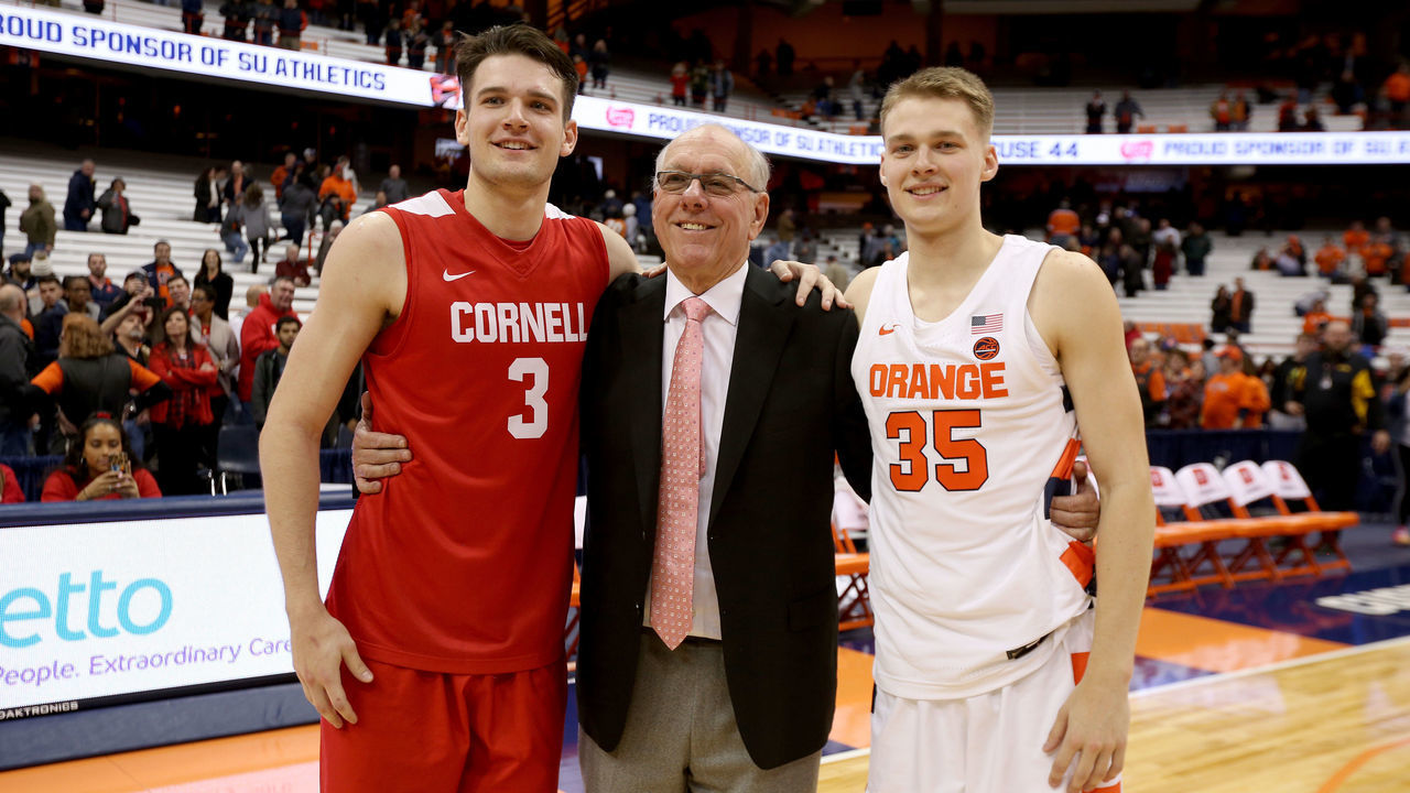 SYRACUSE, NEW YORK - NOVEMBER 20: Jimmy Boeheim #3 of the Cornell Big Red, head coach Jim Boeheim of the Syracuse Orange, and Buddy Boeheim #35 of the Syracuse Orange pose for a photograph after an NCAA basketball game at the Carrier Dome on November 20, 2019 in Syracuse, New York.