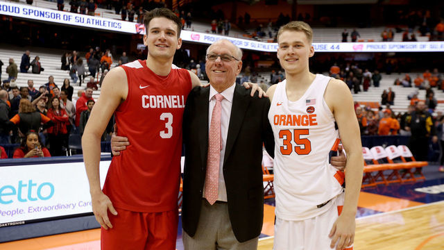 SYRACUSE, NEW YORK - NOVEMBER 20: Jimmy Boeheim #3 of the Cornell Big Red, head coach Jim Boeheim of the Syracuse Orange, and Buddy Boeheim #35 of the Syracuse Orange pose for a photograph after an NCAA basketball game at the Carrier Dome on November 20, 2019 in Syracuse, New York.