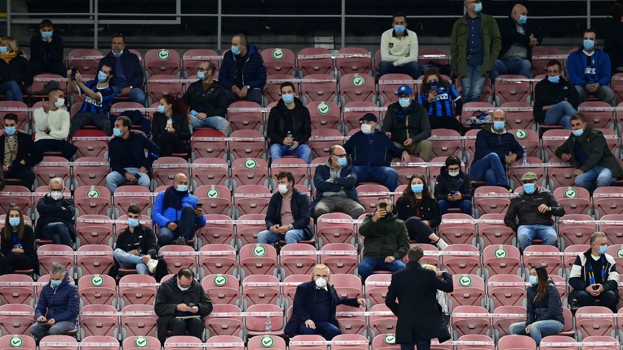 Socially distanced spectators attend the Italian Serie A football match Inter vs Fiorentina on September 26, 2020 at the Giuseppe-Meazza (San Siro) stadium in Milan.