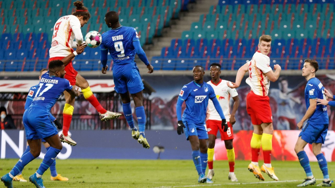 Leipzig's Danish forward Yussuf Poulsen (2nd L) scores goal with his arm in the last minute of the game which was then disallowed for hand ball during the German first divison Bundesliga football match between RB Leipzig and TSG 1899 Hoffenheim in Leipzig, eastern Germany, on April 16, 2021. - DFL REGULATIONS PROHIBIT ANY USE OF PHOTOGRAPHS AS IMAGE SEQUENCES AND/OR QUASI-VIDEO