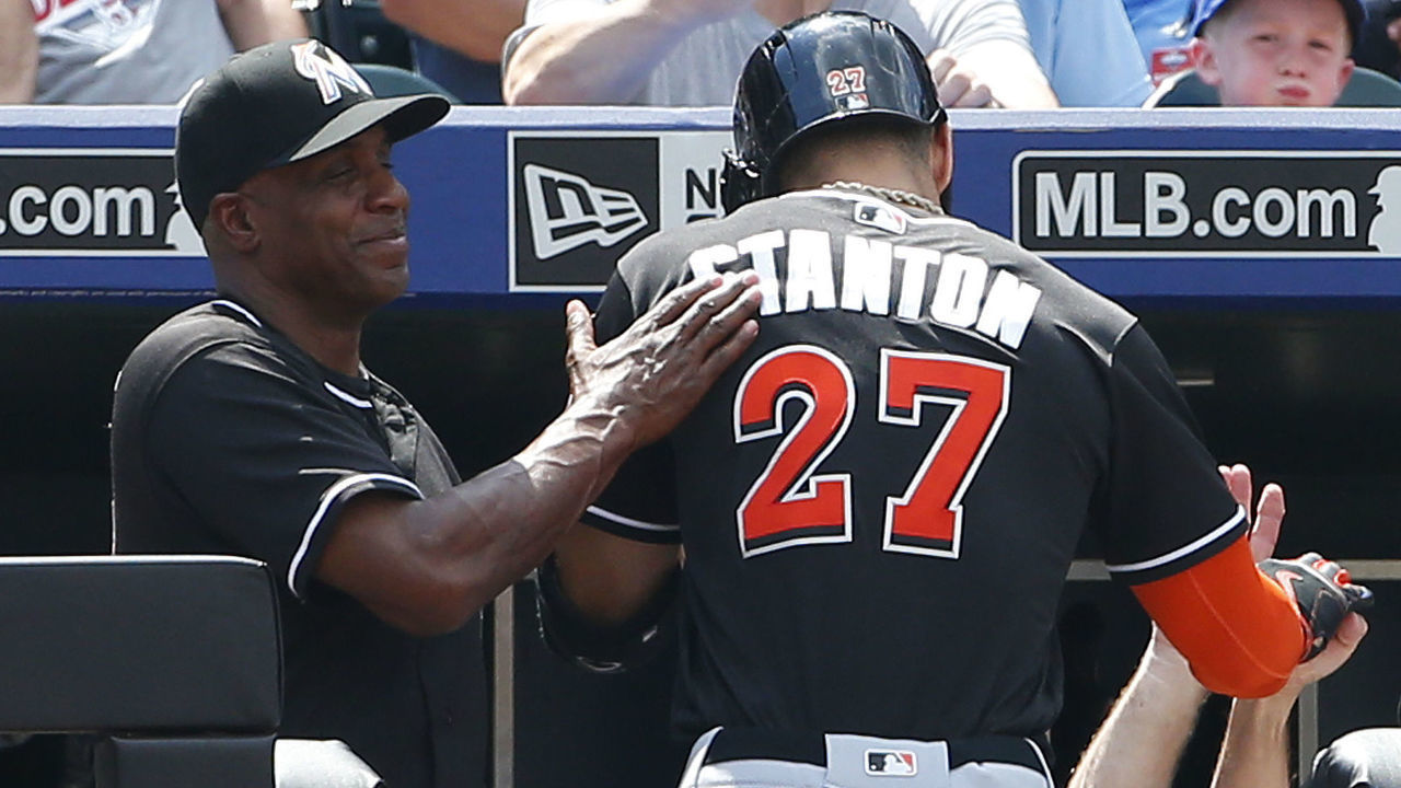 NEW YORK, NY - JULY 06: Giancarlo Stanton #27 of the Miami Marlins gets a pat on the back by hitting coach Barry Bonds #25 after he hit a home run against the New York Mets in the sixth inning during a game against the New York Mets at Citi Field on July 6, 2016 in the Flushing neighborhood of the Queens borough of New York City.