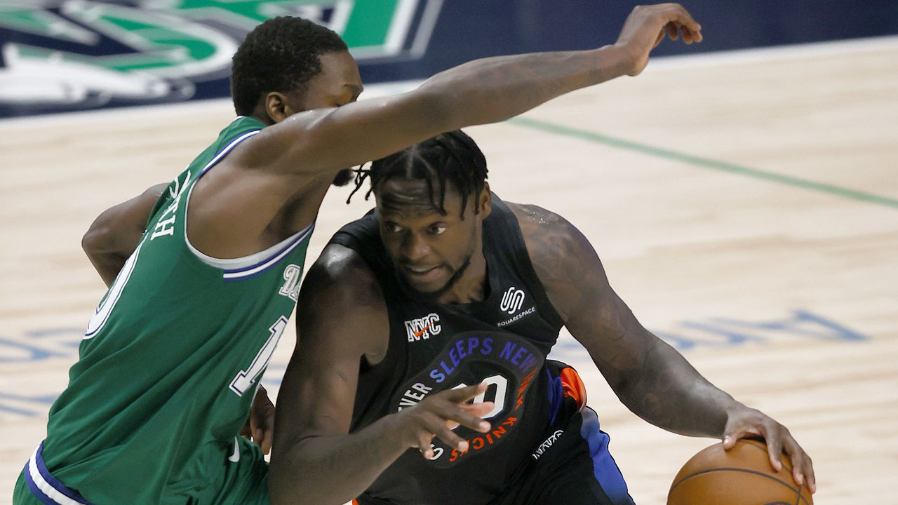 DALLAS, TEXAS - APRIL 16: Julius Randle #30 of the New York Knicks drives to the basket against Dorian Finney-Smith #10 of the Dallas Mavericks in the fourth quarter at American Airlines Center on April 16, 2021 in Dallas, Texas.