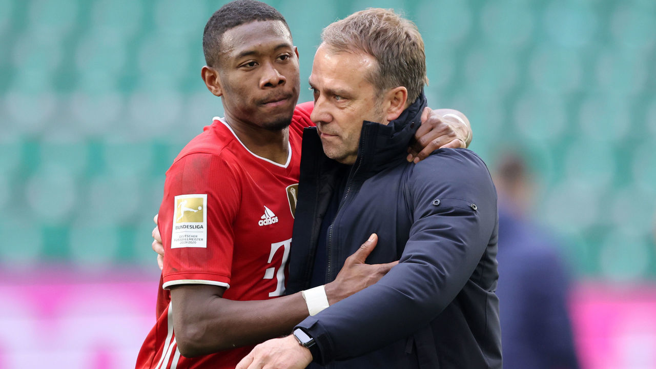 WOLFSBURG, GERMANY - APRIL 17: David Alaba and Coach Hansi Hans Flick of Bayern Muenchen hug after the Bundesliga match between VfL Wolfsburg and FC Bayern Muenchen at Volkswagen Arena on April 17, 2021 in Wolfsburg, Germany. Sporting stadiums around Germany remain under strict restrictions due to the Coronavirus Pandemic as Government social distancing laws prohibit fans inside venues resulting in games being played behind closed doors.