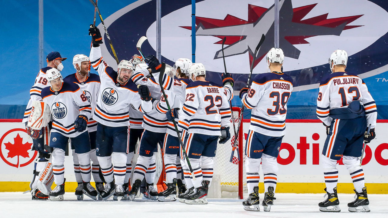 WINNIPEG, MB - APRIL 17: Edmonton Oilers players celebrate on the ice following a 3-0 shutout victory over the Winnipeg Jets at the Bell MTS Place on April 17, 2021 in Winnipeg, Manitoba, Canada.