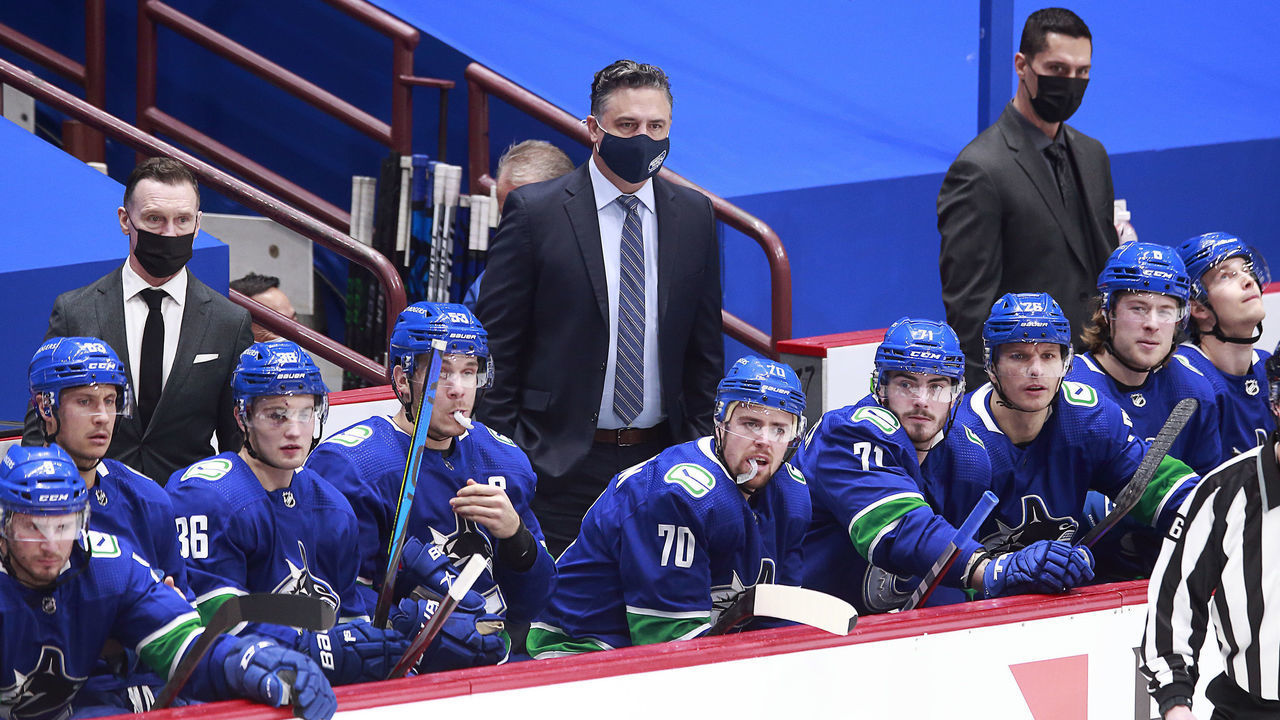 VANCOUVER, BC - FEBRUARY 13: Head coach Travis Green of the Vancouver Canucks looks on from the bench during their NHL game against the Calgary Flames at Rogers Arena on February 13, 2021 in Vancouver, British Columbia, Canada. "n