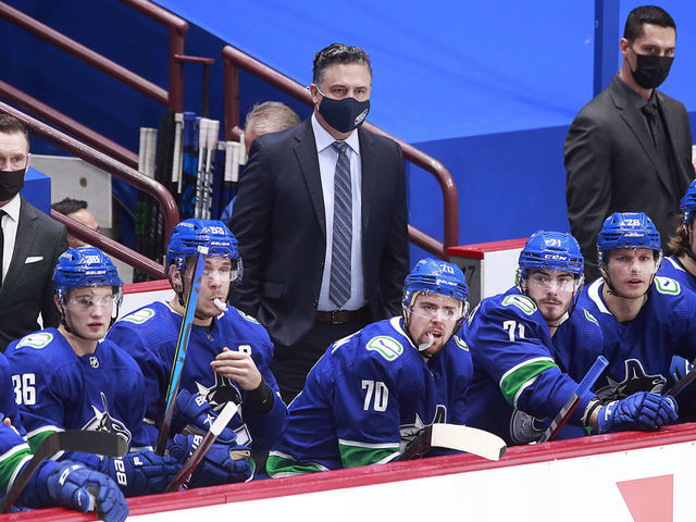 VANCOUVER, BC - FEBRUARY 13: Head coach Travis Green of the Vancouver Canucks looks on from the bench during their NHL game against the Calgary Flames at Rogers Arena on February 13, 2021 in Vancouver, British Columbia, Canada. "n