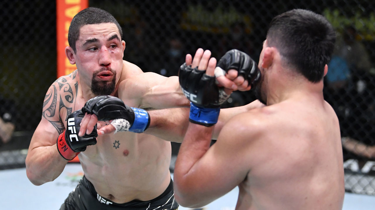 LAS VEGAS, NEVADA - APRIL 17: (L-R) Robert Whittaker of Australia punches Kelvin Gastelum in a middleweight fight during the UFC Fight Night event at UFC APEX on April 17, 2021 in Las Vegas, Nevada.