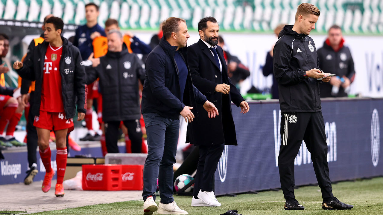 WOLFSBURG, GERMANY - APRIL 17: Hans-Dieter Flick, Head Coach of FC Bayern Muenchen and Sporting Director, Hasan Salihamidzic react after the Bundesliga match between VfL Wolfsburg and FC Bayern Muenchen at Volkswagen Arena on April 17, 2021 in Wolfsburg, Germany. Sporting stadiums around Germany remain under strict restrictions due to the Coronavirus Pandemic as Government social distancing laws prohibit fans inside venues resulting in games being played behind closed doors.