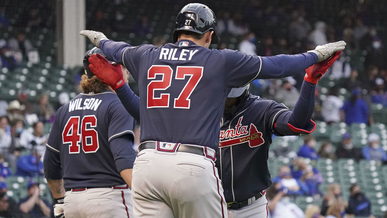 CHICAGO, ILLINOIS - APRIL 18: Guillermo Heredia #38 of the Atlanta Braves is congratulated by Austin Riley #27 following his two run home run during the first inning of a game against the Chicago Cubs at Wrigley Field on April 18, 2021 in Chicago, Illinois.