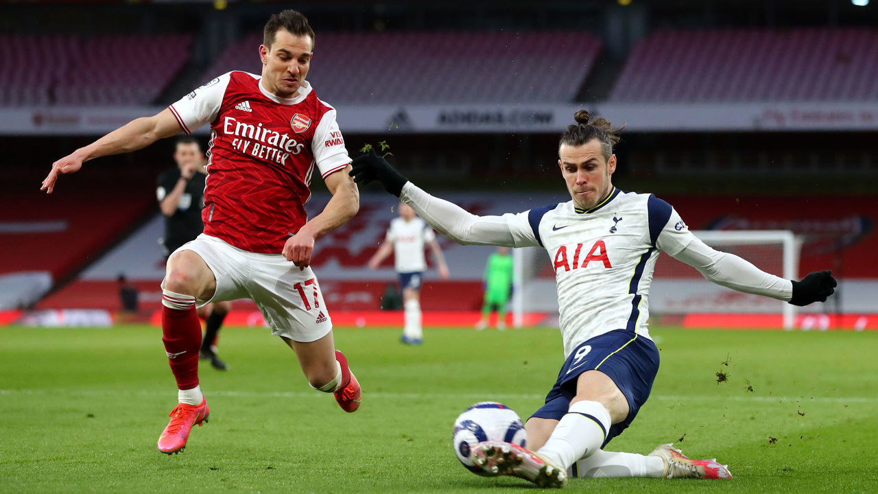 LONDON, ENGLAND - MARCH 14: Gareth Bale of Tottenham Hotspur controls the ball under pressure of Cedric of Arsenal during the Premier League match between Arsenal and Tottenham Hotspur at Emirates Stadium on March 14, 2021 in London, England. Sporting stadiums around the UK remain under strict restrictions due to the Coronavirus Pandemic as Government social distancing laws prohibit fans inside venues resulting in games being played behind closed doors.