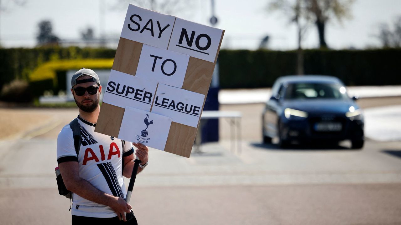 A Tottenham Hotspur's fan holds an anti-European Super League placard has he demonstrates outside the English Premier League football club's training ground in north London on April 19, 2021. - Arsenal and Tottenham Hotspur fans enjoy a fierce rivalry but the announcement of the European Super League achieved the rare feat of uniting them virtually as one in condemning it.