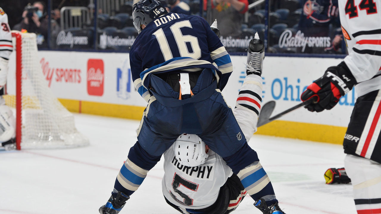 COLUMBUS, OH - APRIL 12: Max Domi #16 of the Columbus Blue Jackets fights with Connor Murphy #5 of the Chicago Blackhawks during the second period of a game at Nationwide Arena on April 12, 2021 in Columbus, Ohio.