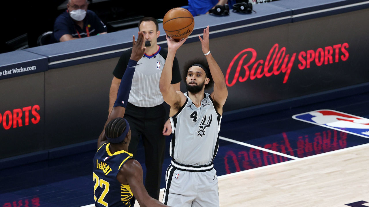 INDIANAPOLIS, INDIANA - APRIL 19: Derrick White #4 of the San Antonio Spurs attempts a shot while guarded by Caris LeVert #22 of the Indiana Pacers in the first quarter at Bankers Life Fieldhouse on April 19, 2021 in Indianapolis, Indiana.