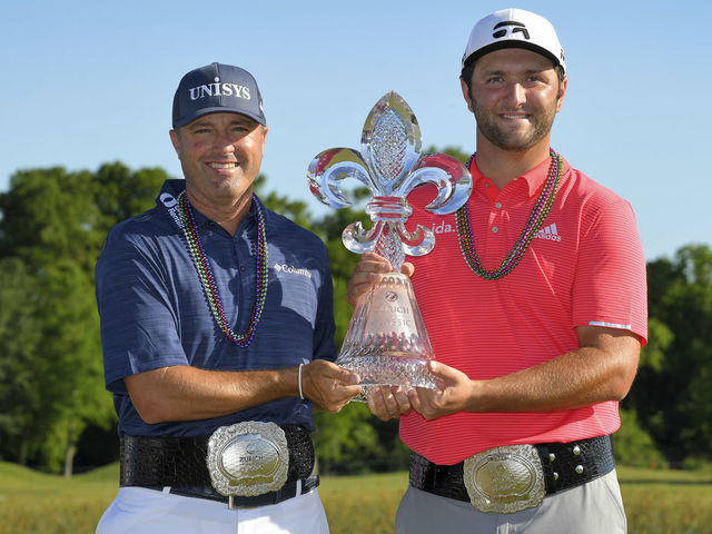 AVONDALE, LA - APRIL 28: Ryan Palmer and Jon Rahm pose with the winner's trophy on the 18th green during the final round of the Zurich Classic of New Orleans at TPC Louisiana on April 28, 2019 in Avondale, Louisiana.