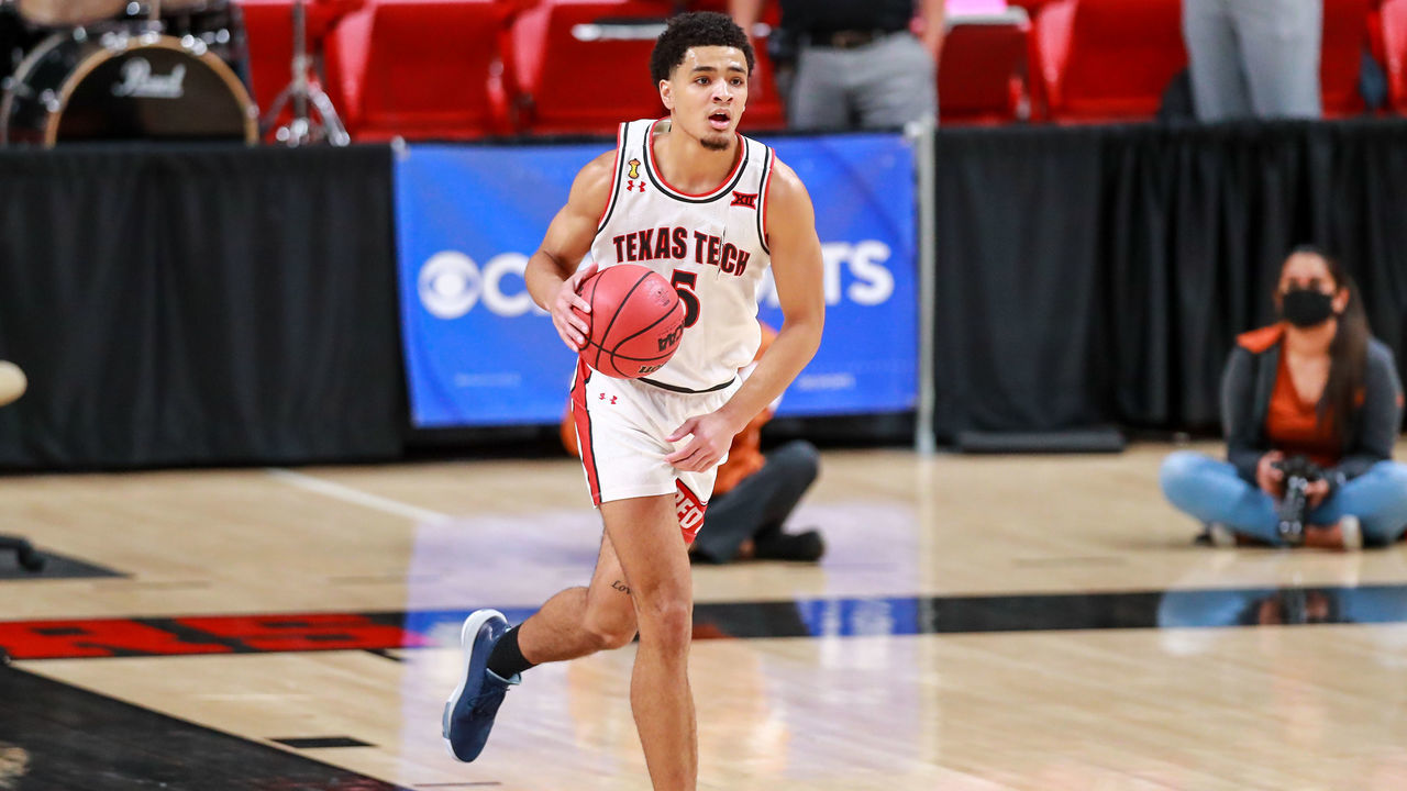 LUBBOCK, TEXAS - FEBRUARY 27: Guard Micah Peavy #5 of the Texas Tech Red Raiders handles the ball during the second half of the college basketball game against the Texas Longhorns at United Supermarkets Arena on February 27, 2021 in Lubbock, Texas.