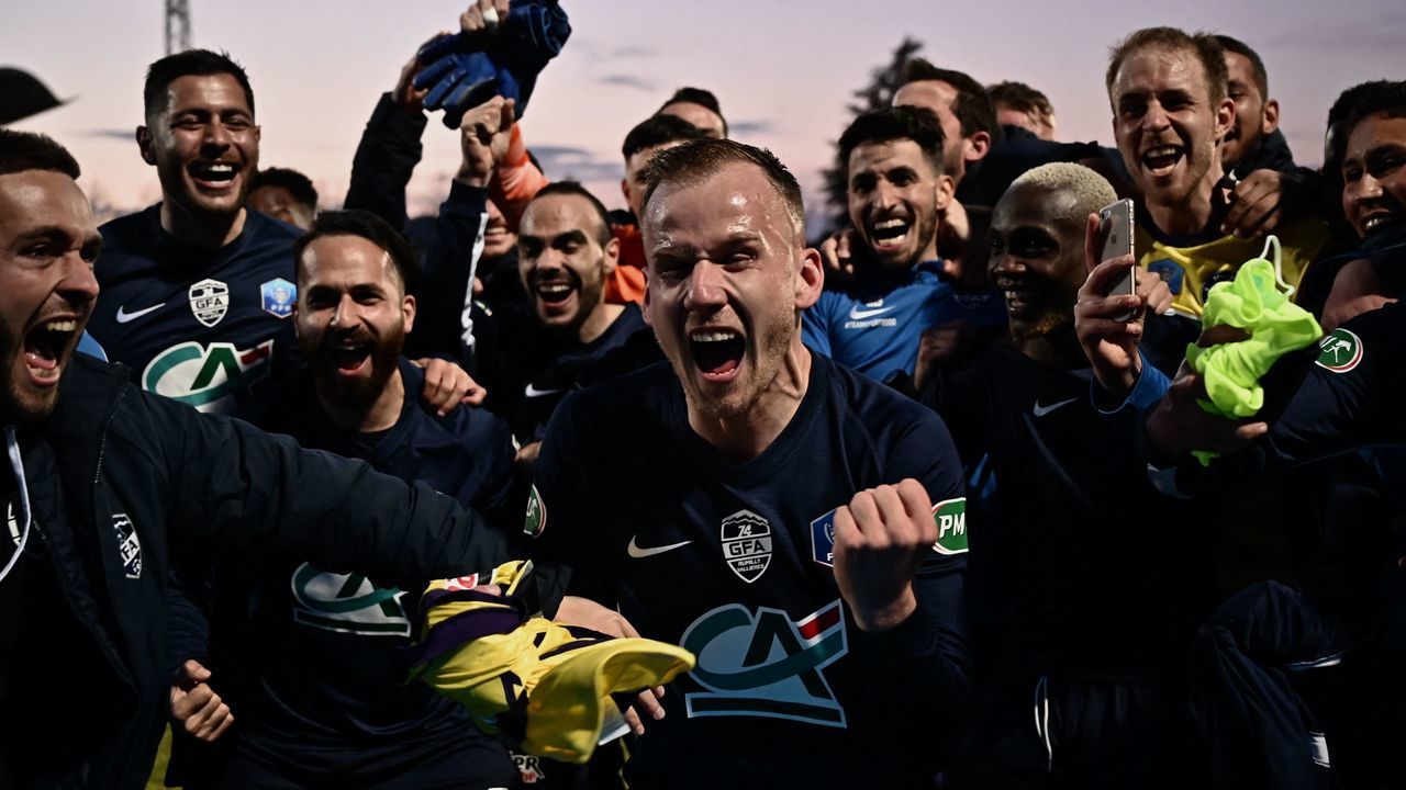 Rumilly-Vallieres players celebrate after winning the French Cup quarter-final football match between GFA Rumilly Vallieres and Toulouse Football Club (TFC) on April 20, 2021, at the Parc des Sports, in Annecy.
