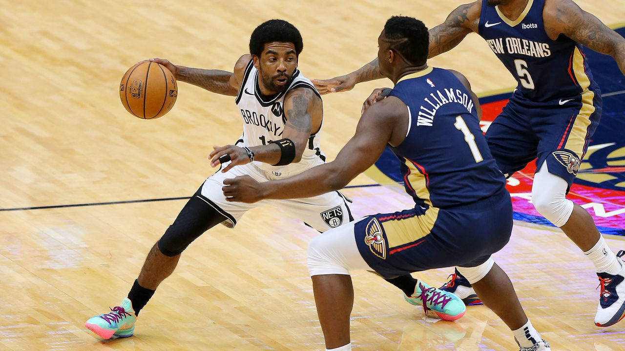 NEW ORLEANS, LOUISIANA - APRIL 20: Kyrie Irving #11 of the Brooklyn Nets drives against Zion Williamson #1 of the New Orleans Pelicans during the first half at the Smoothie King Center on April 20, 2021 in New Orleans, Louisiana.
