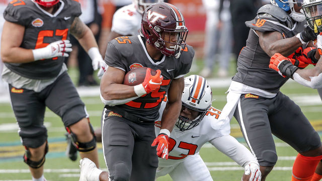 MOBILE, AL - JANUARY 30: Linebacker KJ Britt #33 from Auburn of the American Team makes a tackle on Runningback Khalil Herbert #25 from Virginia Tech during the 2021 Resse's Senior Bowl at Hancock Whitney Stadium on the campus of the University of South Alabama on January 30, 2021 in Mobile, Alabama. The National Team defeated the American Team 27-24.