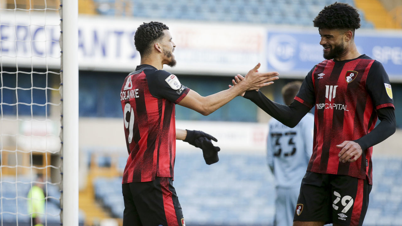 LONDON, ENGLAND - APRIL 21: Dominic Solanke of Bournemouth scores a goal to make it 4-1 and celebrates with team-mate Philip Billing during the Sky Bet Championship match between Millwall and AFC Bournemouth at The Den on April 21, 2021 in London, England. Sporting stadiums around the UK remain under strict restrictions due to the Coronavirus Pandemic as Government social distancing laws prohibit fans inside venues resulting in games being played behind closed doors.