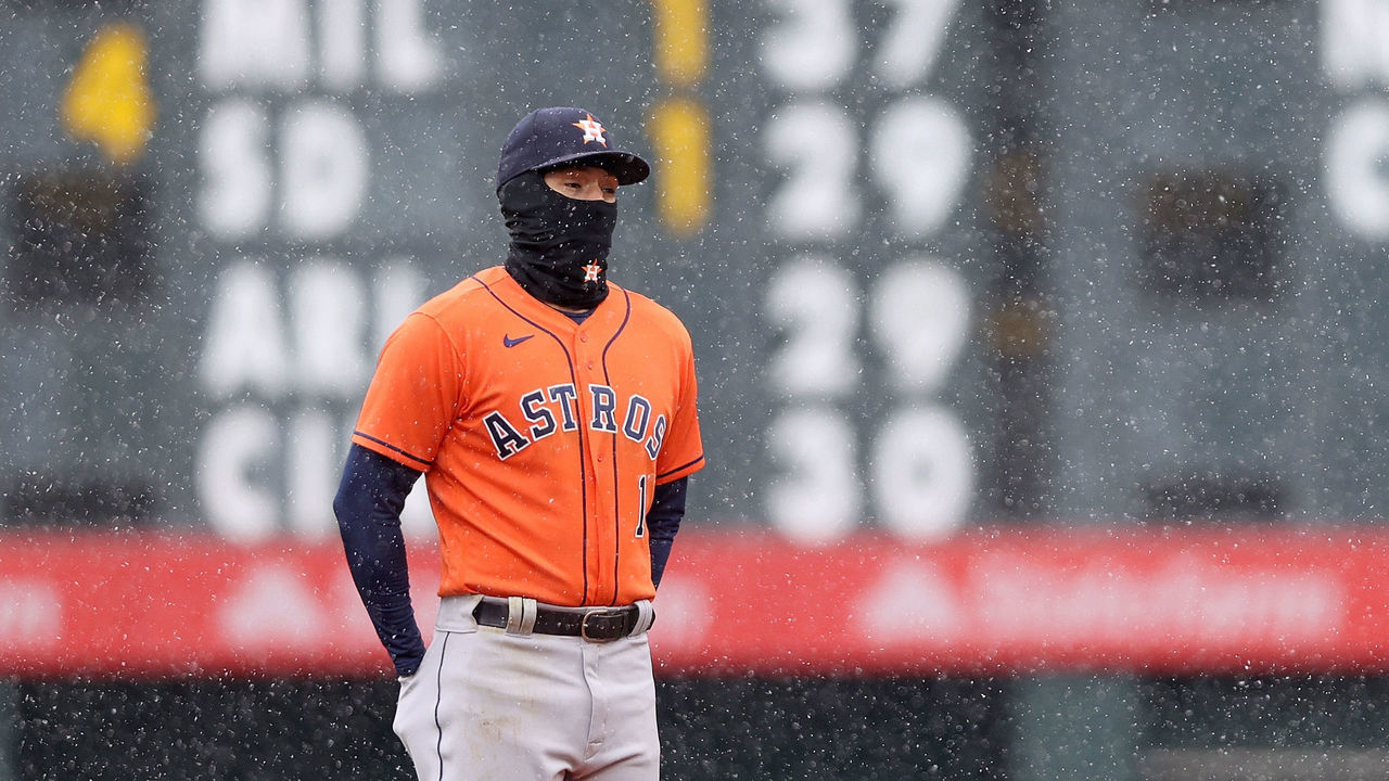 DENVER, COLORADO - APRIL 21: Carlos Correa #1 of the Houston Astros tries to keep his hands warm while playing the Colorado Rockies in the eighth inning at Coors Field on April 21, 2021 in Denver, Colorado.