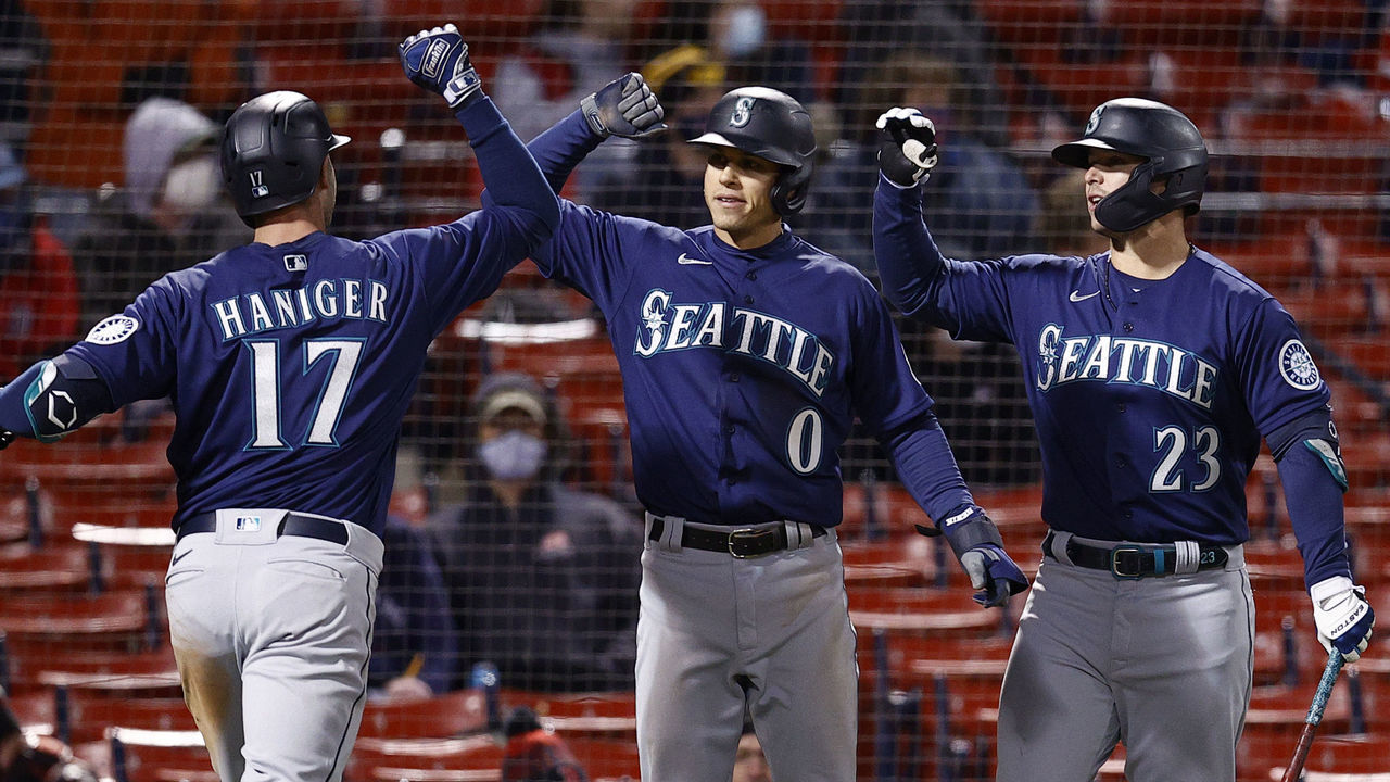 BOSTON, MASSACHUSETTS - APRIL 22: Mitch Haniger #17 of the Seattle Mariners celebrates with Sam Haggerty #0 and Ty France #23 after hitting a three run home run against the Boston Red Sox during the tenth inning at Fenway Park on April 22, 2021 in Boston, Massachusetts.