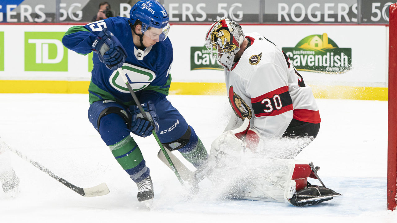 VANCOUVER, BC - APRIL 22: Goalie Matt Murray #30 of the Ottawa Senators stops Matthew Highmore #15 of the Vancouver Canucks during the second period of NHL action at Rogers Arena on April 22, 2021 in Vancouver, Canada.