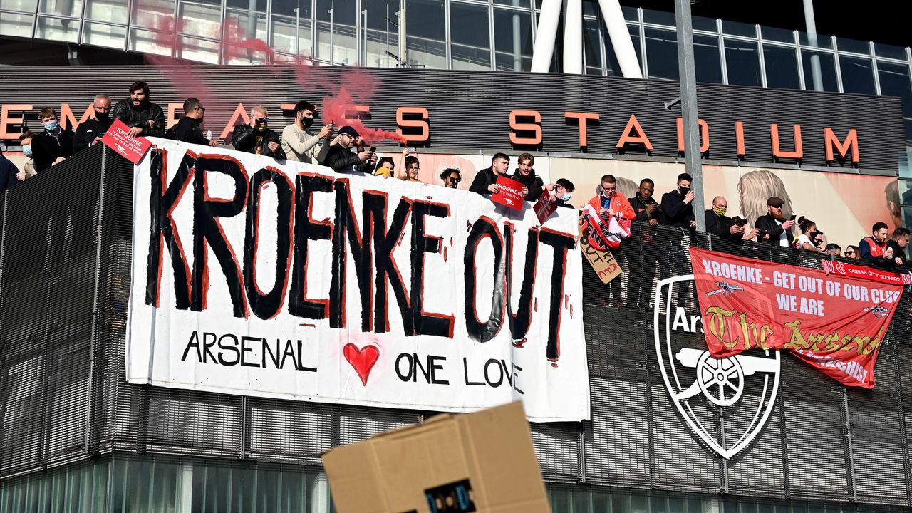 LONDON, ENGLAND - APRIL 23: Arsenal fans display banners during a protest against the club's owner Stan Kroenke ahead of the Premier League match between Arsenal and Everton, outside Emirates Stadium on April 23, 2021 in London, England. The protest, which takes place amid growing discontent over the running Arsenal FC, was sparked by the club's recent involvement in the European Super League. There was uproar from football fans across the country earlier this week when six major Premier League football clubs, including Arsenal, announced that they were to join the controversial "closed-shop" tournament. Each club has subsequently withdrawn from the competition.