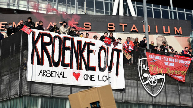 LONDON, ENGLAND - APRIL 23: Arsenal fans display banners during a protest against the club's owner Stan Kroenke ahead of the Premier League match between Arsenal and Everton, outside Emirates Stadium on April 23, 2021 in London, England. The protest, which takes place amid growing discontent over the running Arsenal FC, was sparked by the club's recent involvement in the European Super League. There was uproar from football fans across the country earlier this week when six major Premier League football clubs, including Arsenal, announced that they were to join the controversial "closed-shop" tournament. Each club has subsequently withdrawn from the competition.