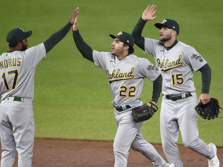 Oakland Athletics' Ramon Laureano, left, is tagged out by Houston