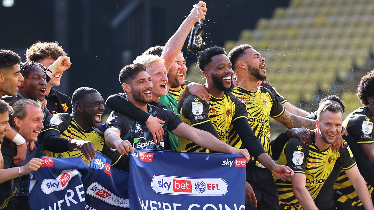 WATFORD, ENGLAND - APRIL 24: Players of Watford celebrate at the final whistle as they are Promoted to the Premier League following the Sky Bet Championship match between Watford and Millwall at Vicarage Road on April 24, 2021 in Watford, England. Sporting stadiums around the UK remain under strict restrictions due to the Coronavirus Pandemic as Government social distancing laws prohibit fans inside venues resulting in games being played behind closed doors.