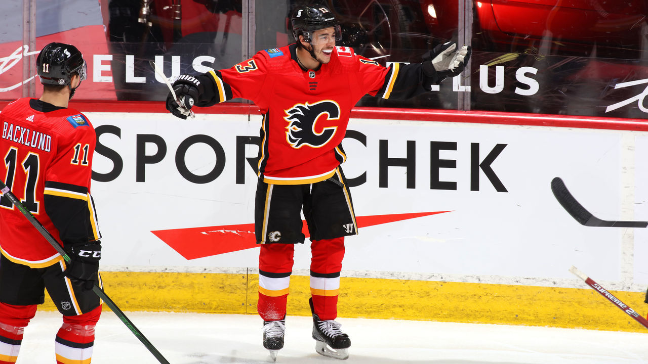 CALGARY, ALBERTA - APRIL 24: Johnny Gaudreau #13 and teammates of the Calgary Flames celebrate a goal against the Montreal Canadiens at Scotiabank Saddledome on April 24, 2021 in Calgary, Alberta.